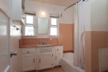 bathroom with original cabinetry and tile