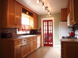 Kitchen, view of laundry room with London phone booth doors